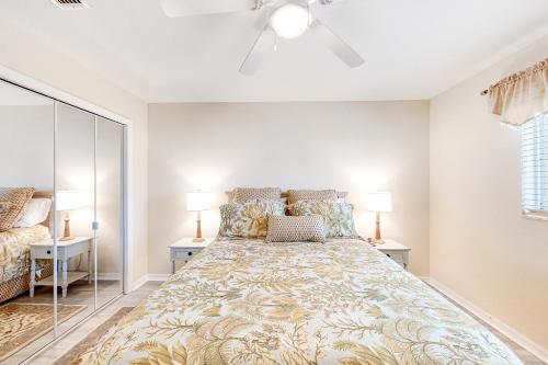 a large bed in a bedroom with two lamps at Life at the Canal in Cape Coral