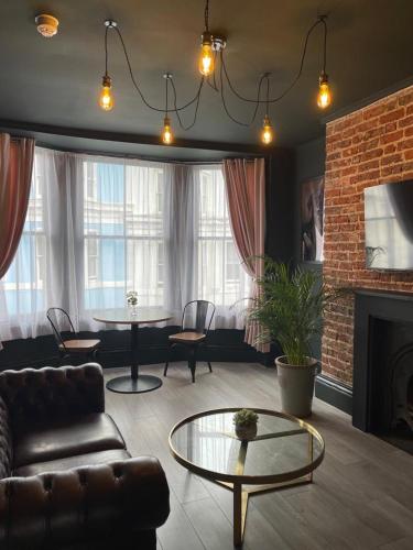 a living room with a couch and a table at Salt Life One Bedroom Apartment in Brighton & Hove