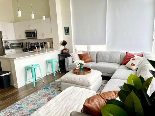 a living room with a couch and a kitchen at A Perfect Getaway in the Heart of the Action in Las Vegas