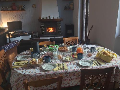 a table with food on it with a fireplace at L'Angolo Divino in Casella