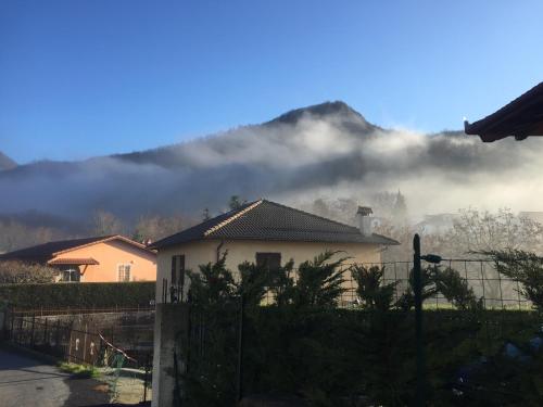 a house with a fence in front of a mountain at L'Angolo Divino in Casella