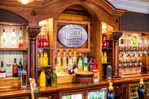 a bar with a lot of bottles of alcohol at Toby Carvery Edinburgh West by Innkeeper's Collection in Edinburgh