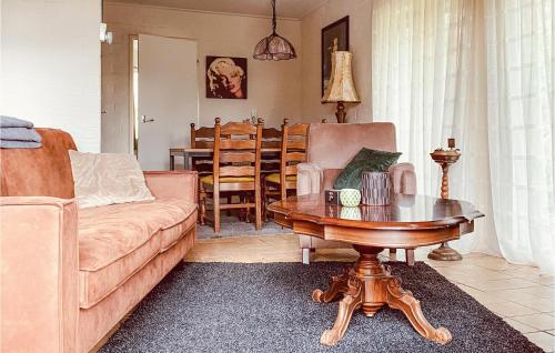 a living room with a couch and a table at Beautiful stacaravan In Rheezerveen With Kitchen in Rheezerveen