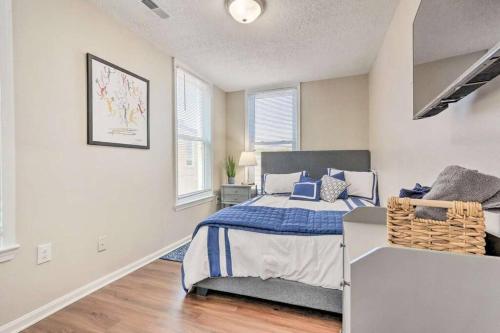 a bedroom with a bed with a blue blanket at Newly Renovated, Quaint, Modern 2-Bedroom Loft in Front Royal