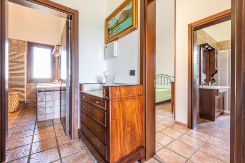 a bathroom with a wooden dresser and a mirror at Villa Rita in Racale