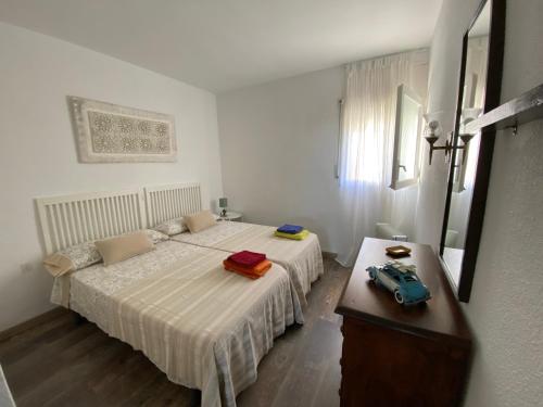 a bedroom with two beds and a table with a toy car on it at Politur in Platja  d'Aro