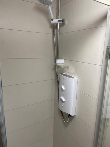 a shower in a bathroom with a soap dispenser at Shindilla Cottage Air B&B in Galway