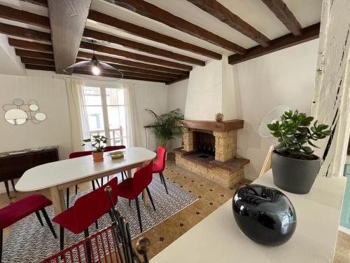 a living room with a table and a fireplace at SPACIEUSE MAISON DE VILLE avec garage privé fermé in Ay