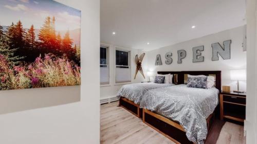 a bedroom with a bed with a sign on the wall at Ski In, Ski Out, 2 Bedroom Luxury Residence With Hot Tub Access And Expansive Views in Snowmass Village