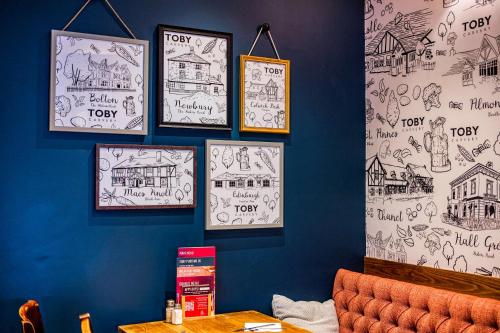 a room with drawings on the wall of a restaurant at Toby Carvery Edinburgh West by Innkeeper's Collection in Edinburgh
