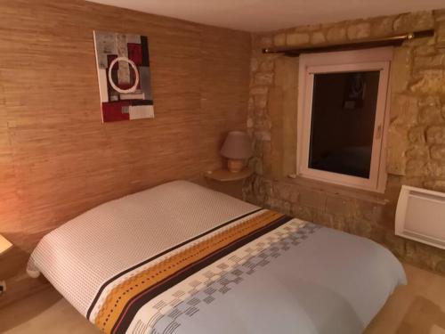 ein kleines Schlafzimmer mit einem Bett und einem Fenster in der Unterkunft GITE LA LOUTRE in Stenay