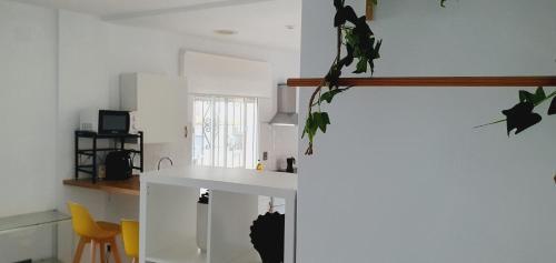 a kitchen with a white counter and a sink at Apartamentos La Libertad Estepona in Estepona