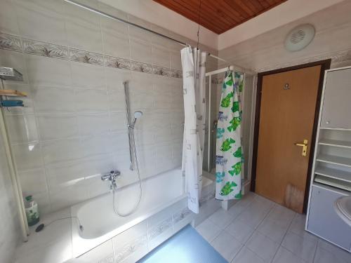 a bathroom with a shower and a tub and a sink at Seaview apartment Marta in Crveni Vrh