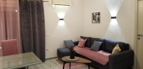 a living room with a couch and two lights at Aparthotel Monterria in Bar