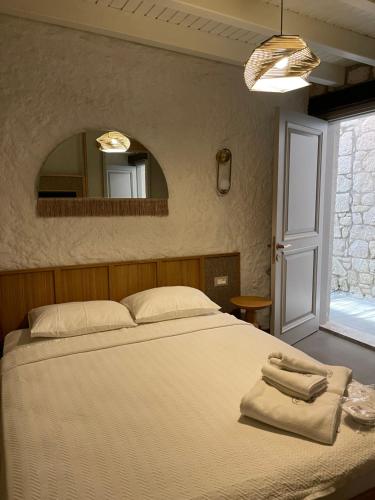 a bedroom with a bed with two towels on it at Monk Hotel Alaçatı in Alacati