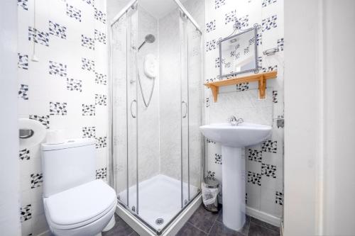 a bathroom with a shower and a toilet and a sink at Blencathra in Whitby