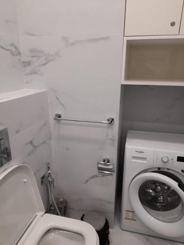 uma casa de banho com um WC e uma máquina de lavar roupa em White King em Tbilisi