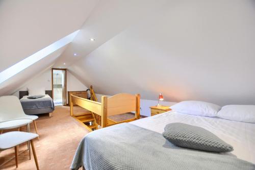 a bedroom with a bed and a desk and a chair at Willa Teresa in Karpacz
