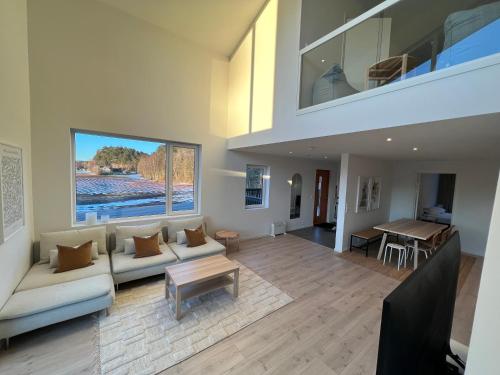 a living room with a couch and a table at Ferie bolig på Sørlandet in Kristiansand