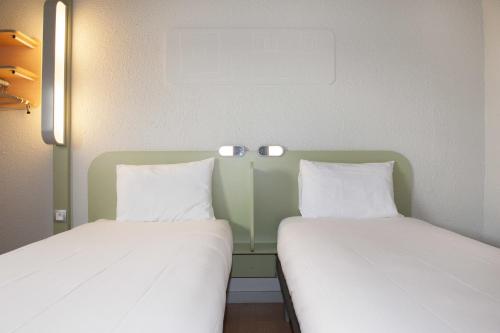 Ένα ή περισσότερα κρεβάτια σε δωμάτιο στο ibis budget Goussainville Charles de Gaulle