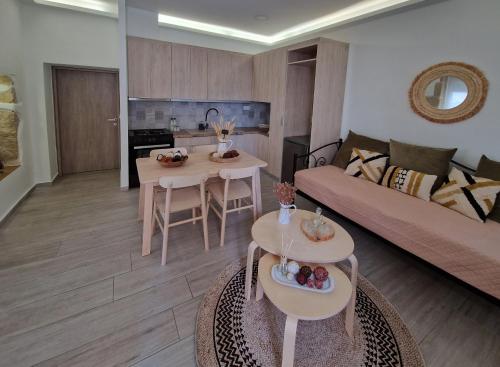 a living room with a couch and a table at Granny's Nest in Kalyves