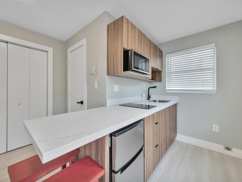 a kitchen with a white counter top and a microwave at The Shell on Walnut Studio Hollywood Beach Free Parking in Dania Beach
