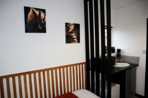 a bathroom with a sink and two pictures on the wall at 259A Queen Ediths Way in Cherry Hinton