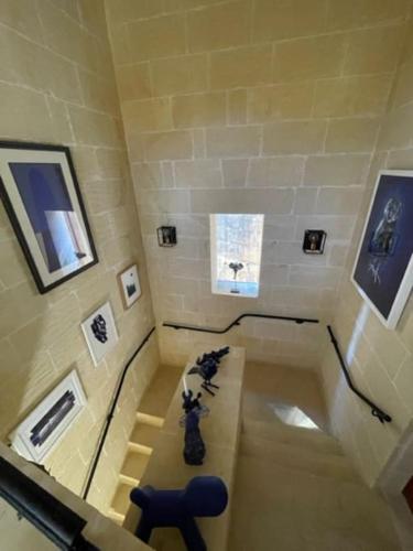 a room with a table and a blue chair at Dar Dragun: luxury 3BR bright spacious house & pool in San Lawrenz
