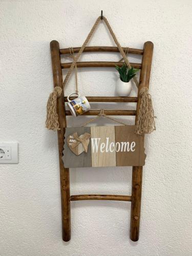 a welcome sign is hanging on a wall at Markovic Village Apartments in Ulcinj