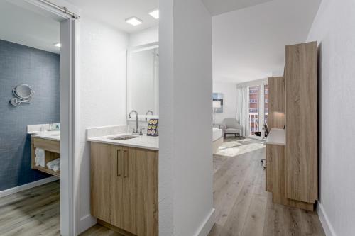 a white kitchen with a sink and a mirror at Perdido Beach Resort in Orange Beach