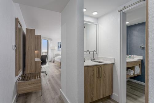 a bathroom with a sink and a mirror at Perdido Beach Resort in Orange Beach