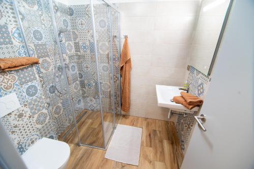 a bathroom with a shower and a sink at Penzion U Vinaře in Mikulov