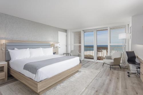 a bedroom with a bed and a view of the ocean at Perdido Beach Resort in Orange Beach
