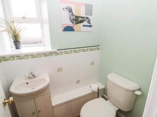 a bathroom with a toilet and a sink at The Steadings in Morpeth