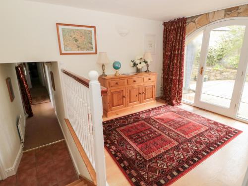 a room with a staircase with a rug and a door at The Steadings in Morpeth