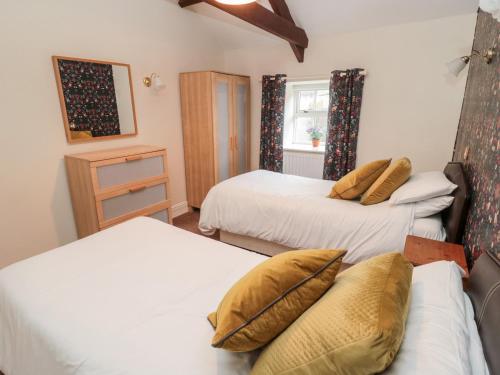 a bedroom with two beds and a window at The Steadings in Morpeth