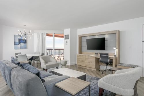 a living room with a couch and a tv at Perdido Beach Resort in Orange Beach