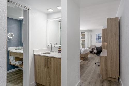 a bathroom with a sink and a room with a bed at Perdido Beach Resort in Orange Beach