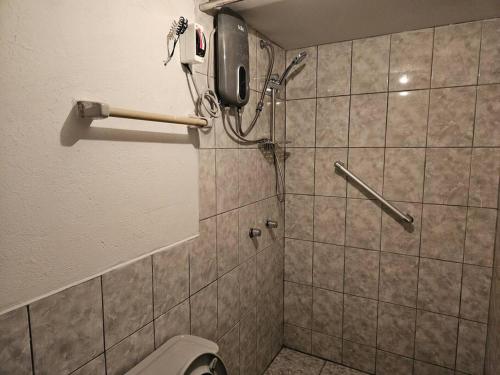 a bathroom with a shower with a toilet and a phone at Cozzy apartment en pleno Centro! in Ayacucho