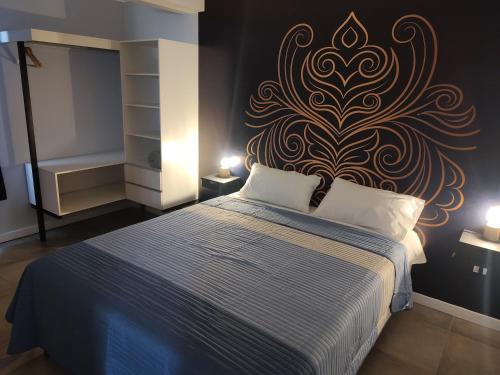 a bedroom with a bed with a wall mural at 787 Suites in La Cieneguita