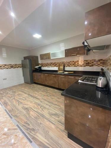 a large kitchen with wooden floors and a counter top at Appartement Lux Safi in Safi