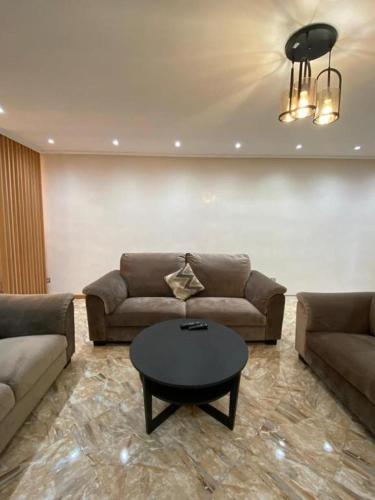 a living room with a couch and a coffee table at Appartement Lux Safi in Safi
