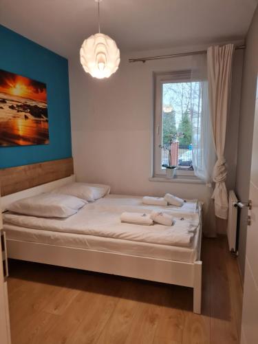 a bedroom with a bed with towels on it at ApartamentyPrzyMorzu 010 z Basenem Tarasem i Ogródkiem in Kołobrzeg