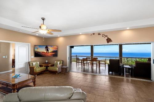 a living room with a view of the ocean at Kailua-Kona Exceptional Oceanview Home - Heated Oasis Pool & Stunning Ocean View in Kailua-Kona