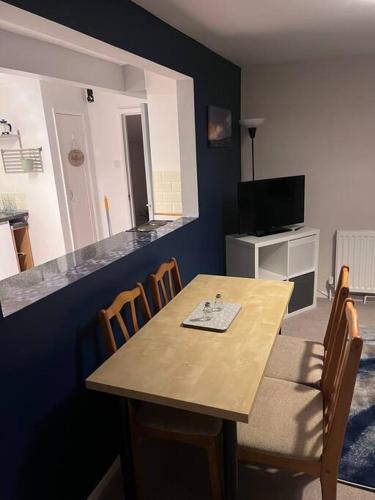 a dining room with a wooden table and chairs at Bay View Retreat in Paignton