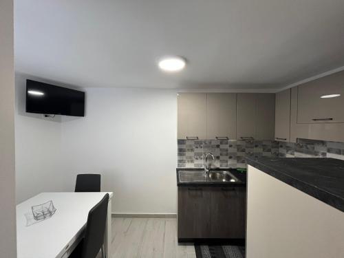 a kitchen with a sink and a counter top at Il nido d'amore in Paola