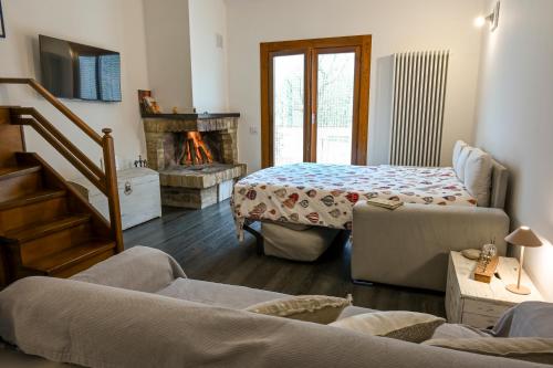 a living room with a couch and a fireplace at Profumo di Bosco in Spoleto