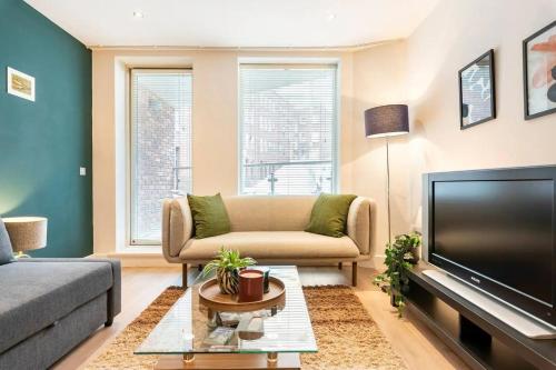 a living room with a couch and a flat screen tv at Cosy and modern apartment in the heart of Dublin in Dublin