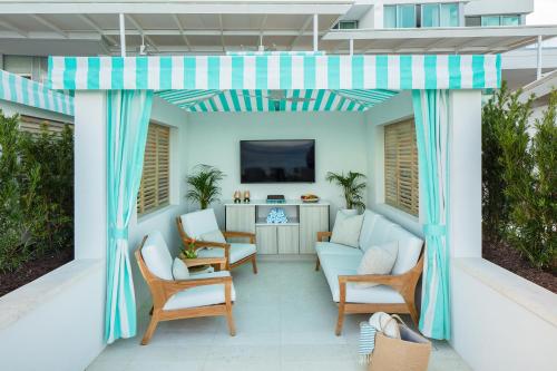 a patio with a couch and chairs on a balcony at Goldwynn Resort & Residences in Nassau