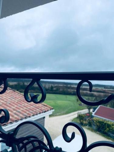a view of a balcony with a view of a house at Maison Spacieuse au Calme Piscine Privée in Boudy